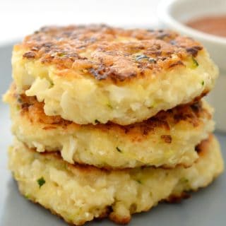 Cauliflower fritters stacked on plate