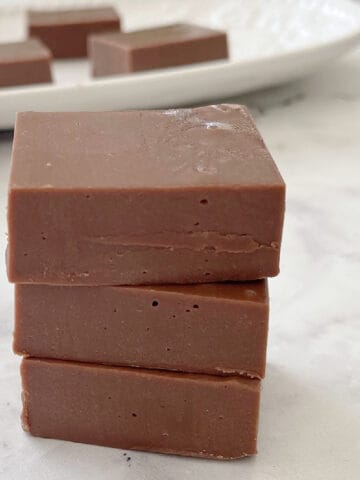 three pieces of chocolate fudge stacked on top of each other.