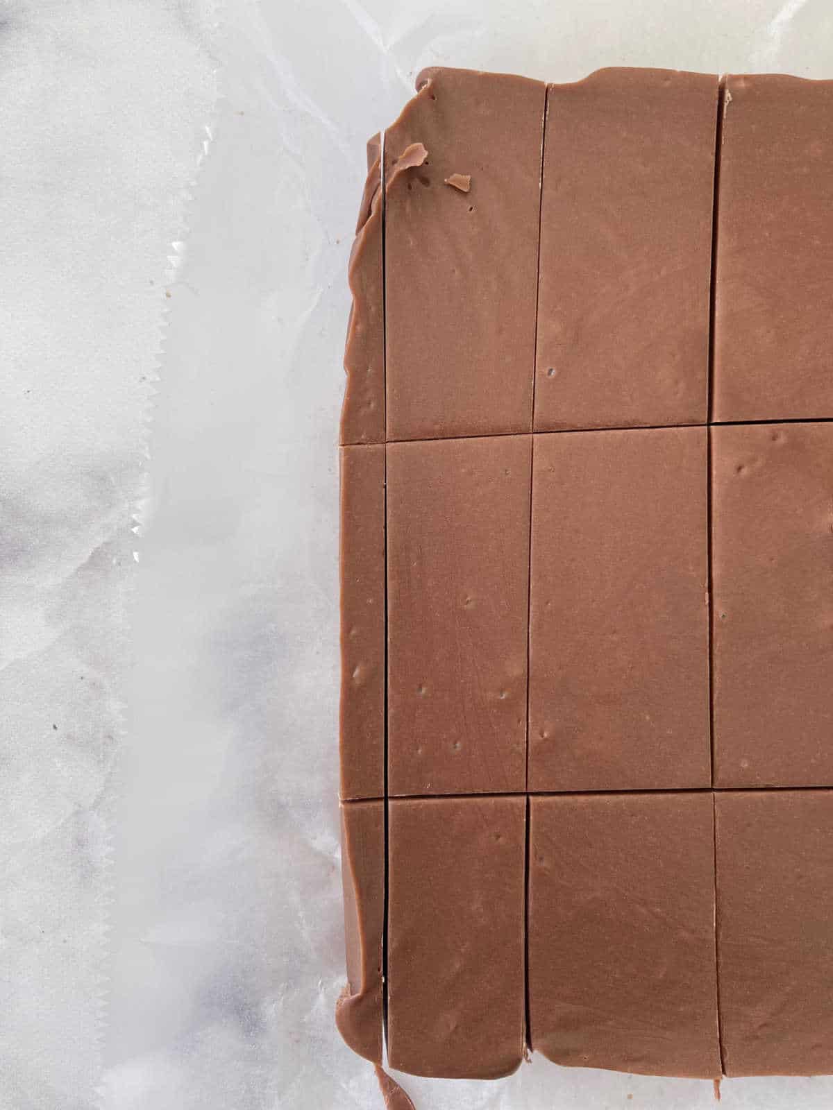 sliced chocolate fudge on marble background.