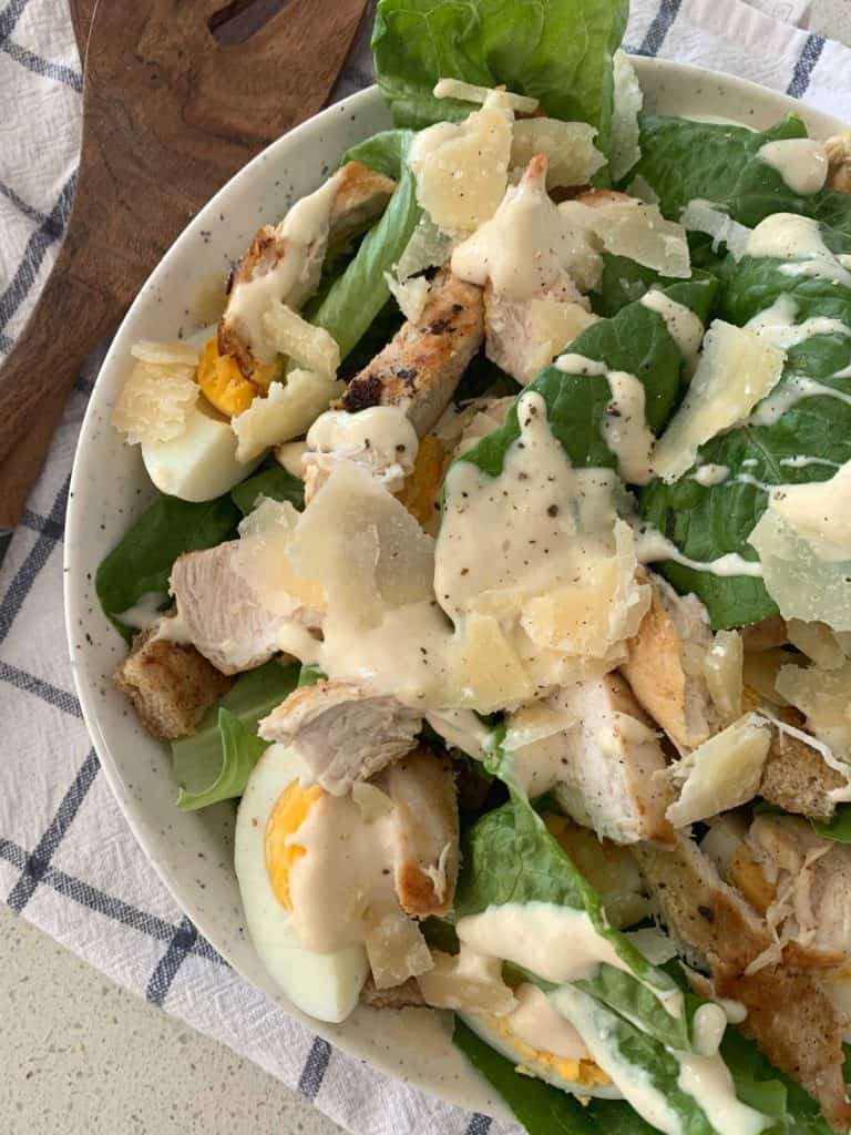 overhead view of chicken caesar salad in a bowl