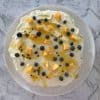 Pavlova topped with mango, passionfruit and blueberries