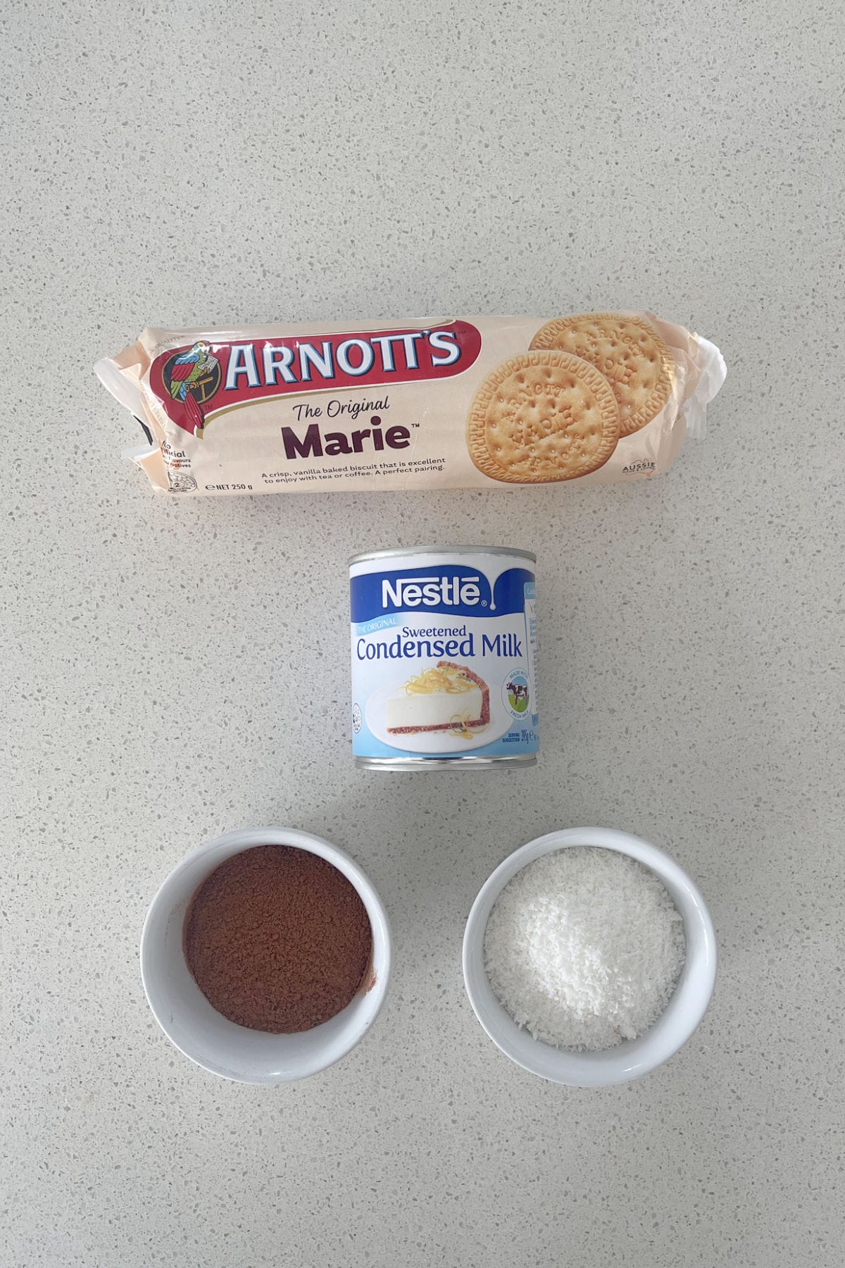 Ingredients to make Milo Balls on a speckled bench top.