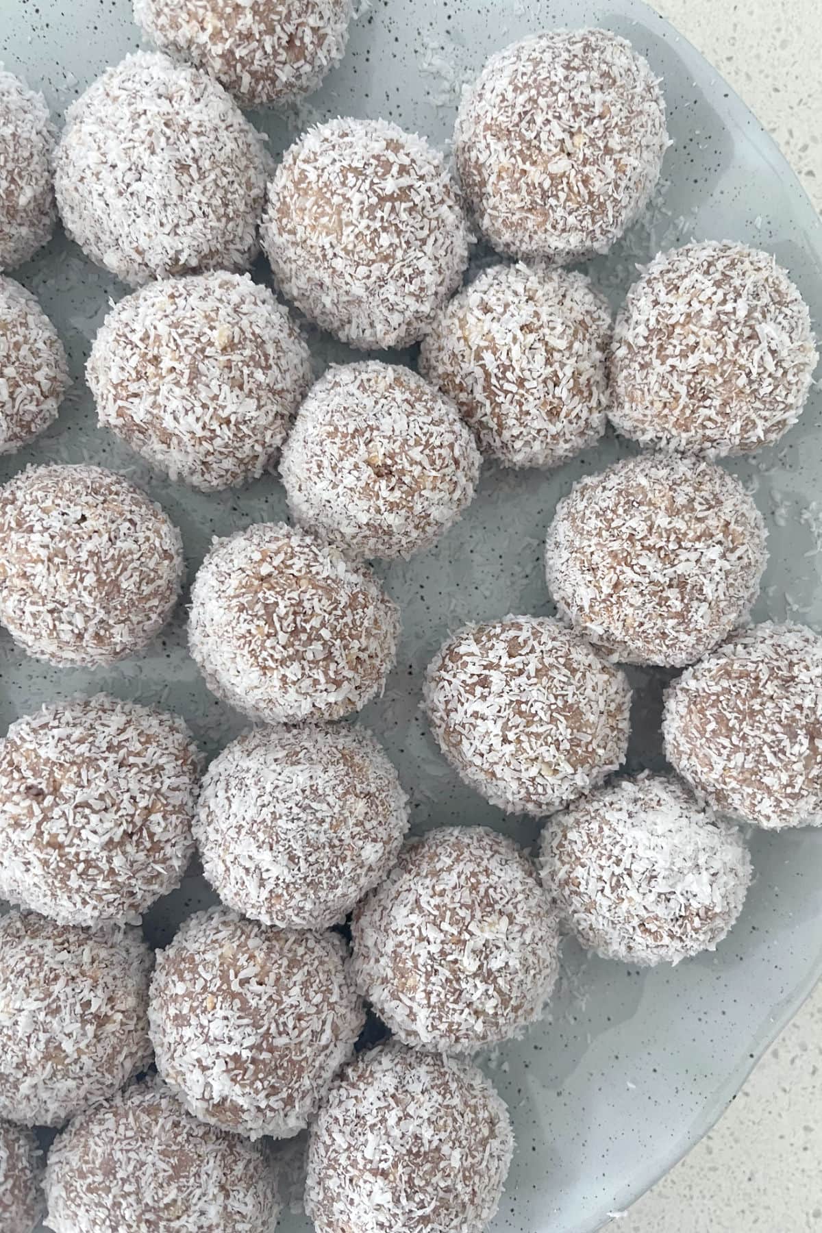 Close up of milo balls on a green speckled plate.