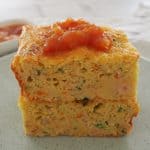Side view of Thermomix zucchini slice on a green plate