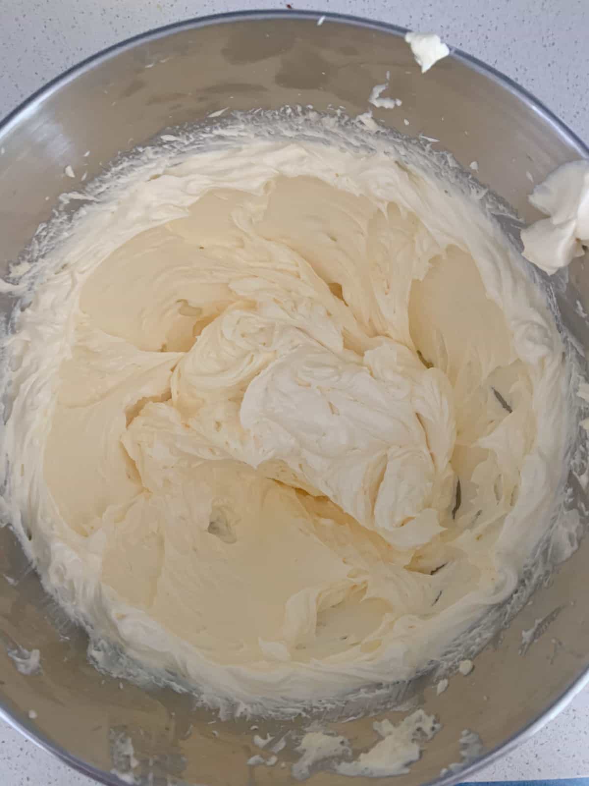 sweetened condensed milk, sugar and butter combined in a mixer bowl.