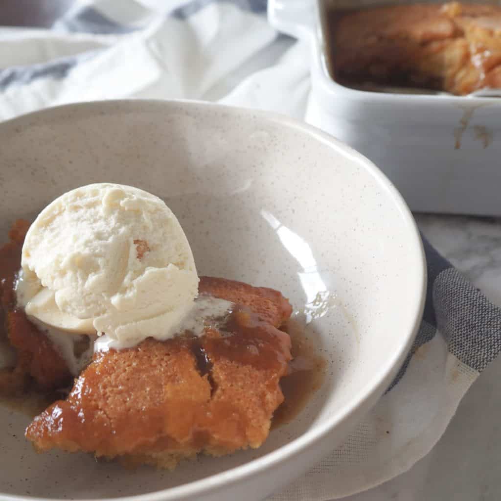 picture of Self saucing butterscotch pudding in a bowl with ice cream on top
