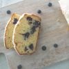 overhead view of sliced lemon and blueberry loaf on timber board