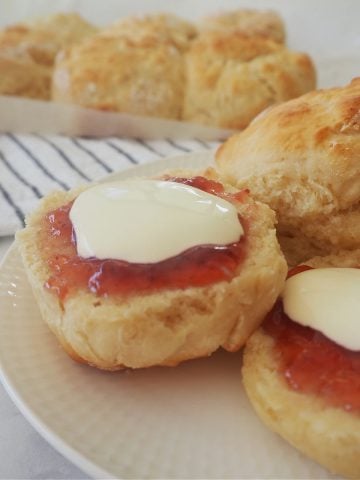 Lemonade Scones on a plate with strawberry jam and cream