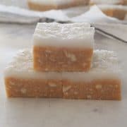 close up of no bake lemon slice pieces stacked in a pyramid