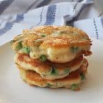 Pea Fritters stacked on a white plate