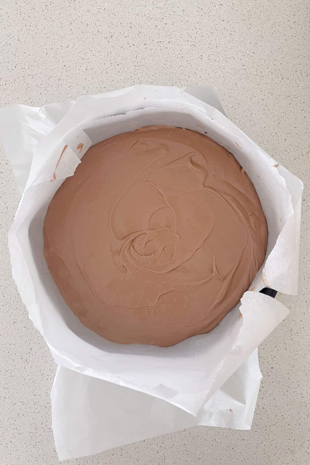 Overhead view of a toblerone cheesecake ready to go into the fridge.
