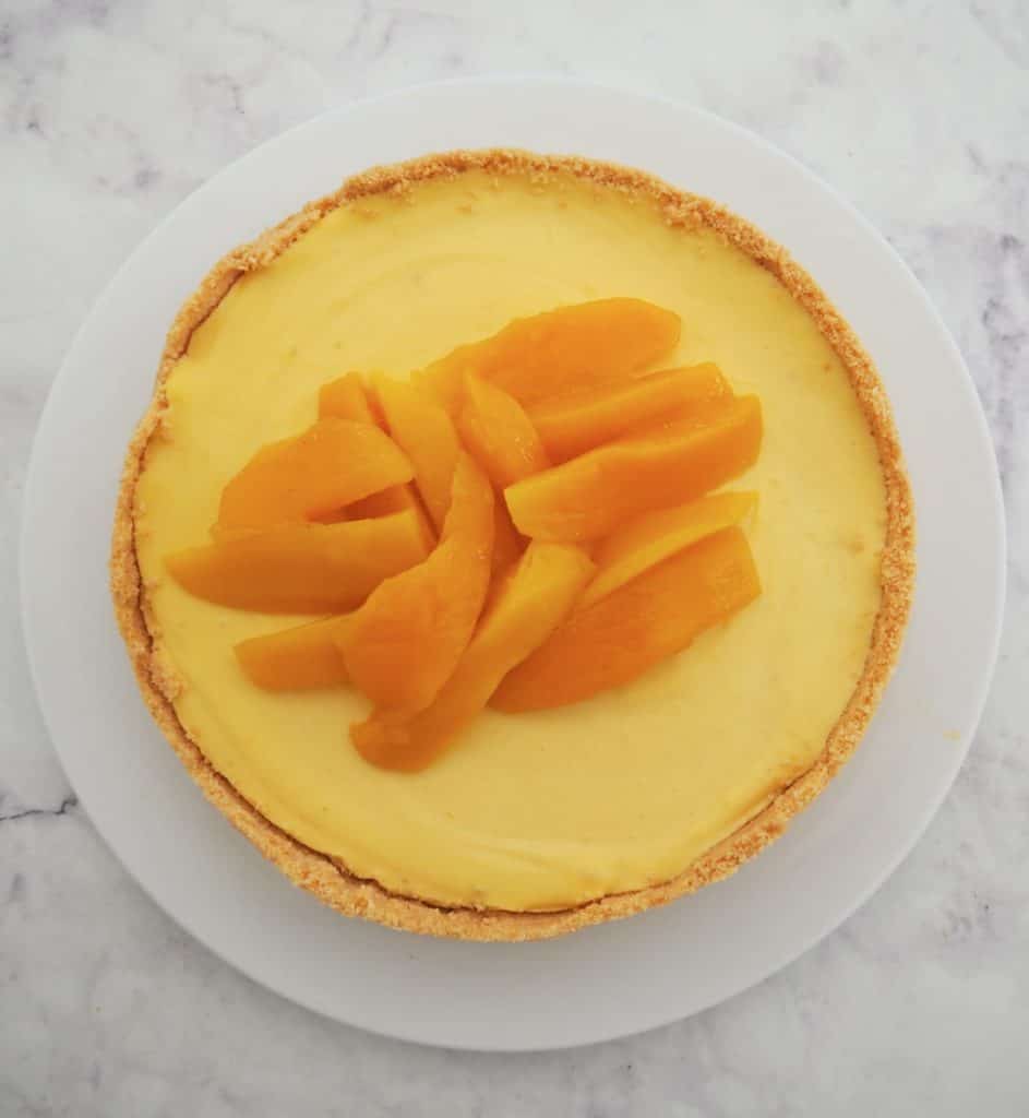 Overhead view of a whole mango cheesecake