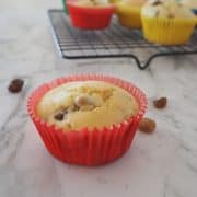 Raisin Muffin in red paper case on a marble background