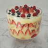Christmas Berry Trifle in a glass bowl on a marble background