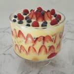 Christmas Berry Trifle in a glass bowl on a marble background