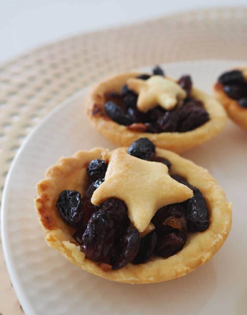 Fruit Mince Pies on a white plate with gold background