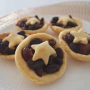 Fruit Mince Pies on a white plate with gold background