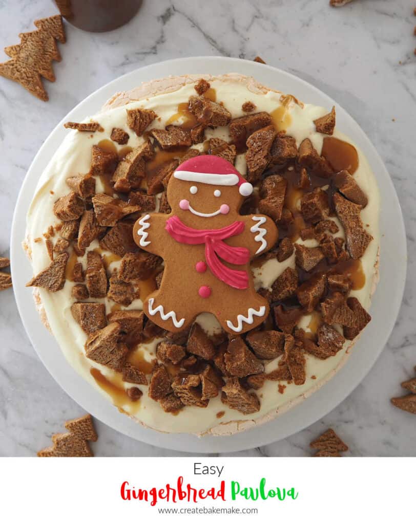 Gingerbread Pavlova on a white plate with gingerbread christmas trees around 