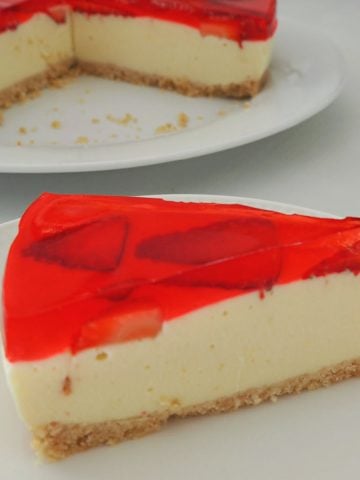 slice of Strawberry Jelly Cheesecake on a white plate