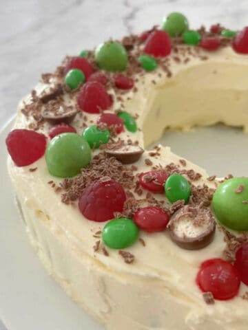 Christmas Wreath Chocolate Ripple Cake on a white plate and marble bench top