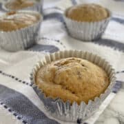 Close up of an ABCD muffin on a marble bench with blue and white stripe towel in background