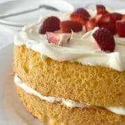 Sponge Cake with Jam and Cream on a white plate.
