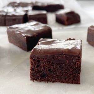 chocolate brownies on a white marble tray.