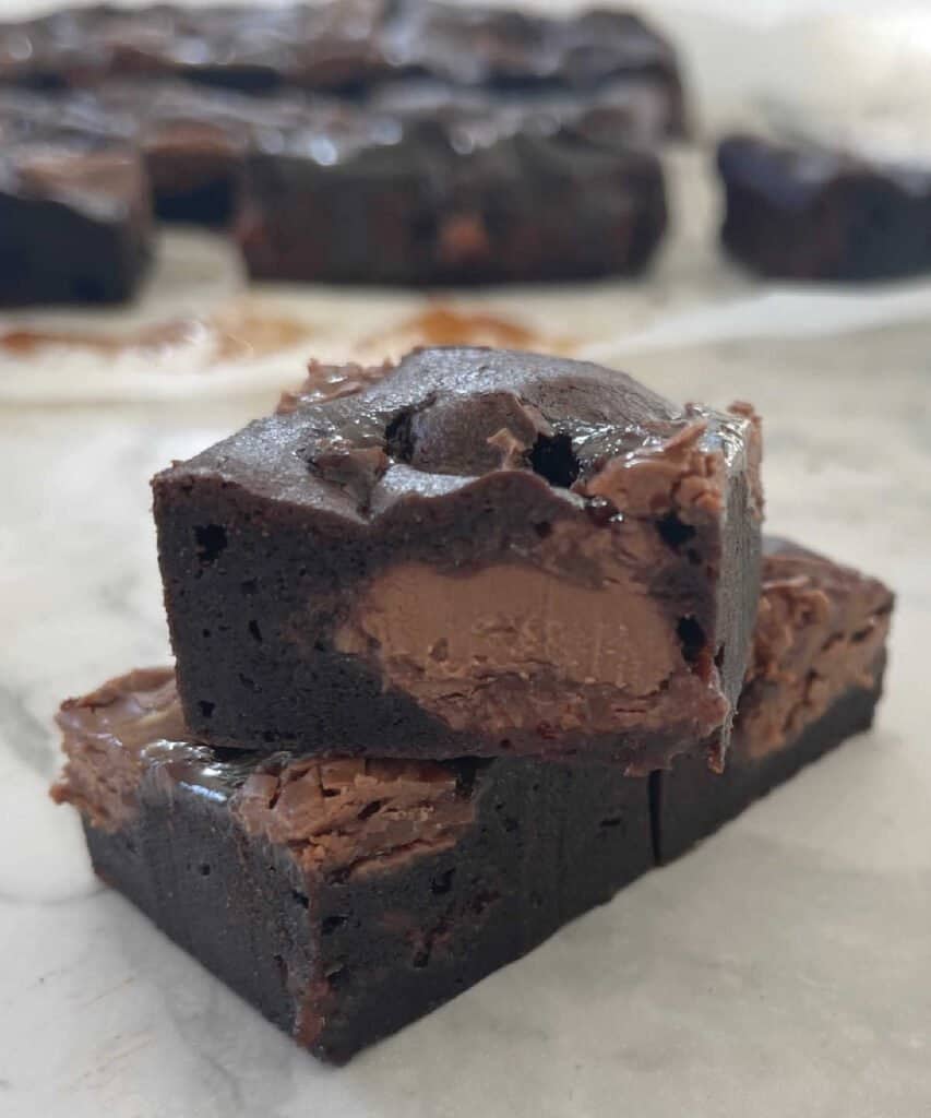 Three pieces of Easter Egg Brownies stacked on top of each other. 