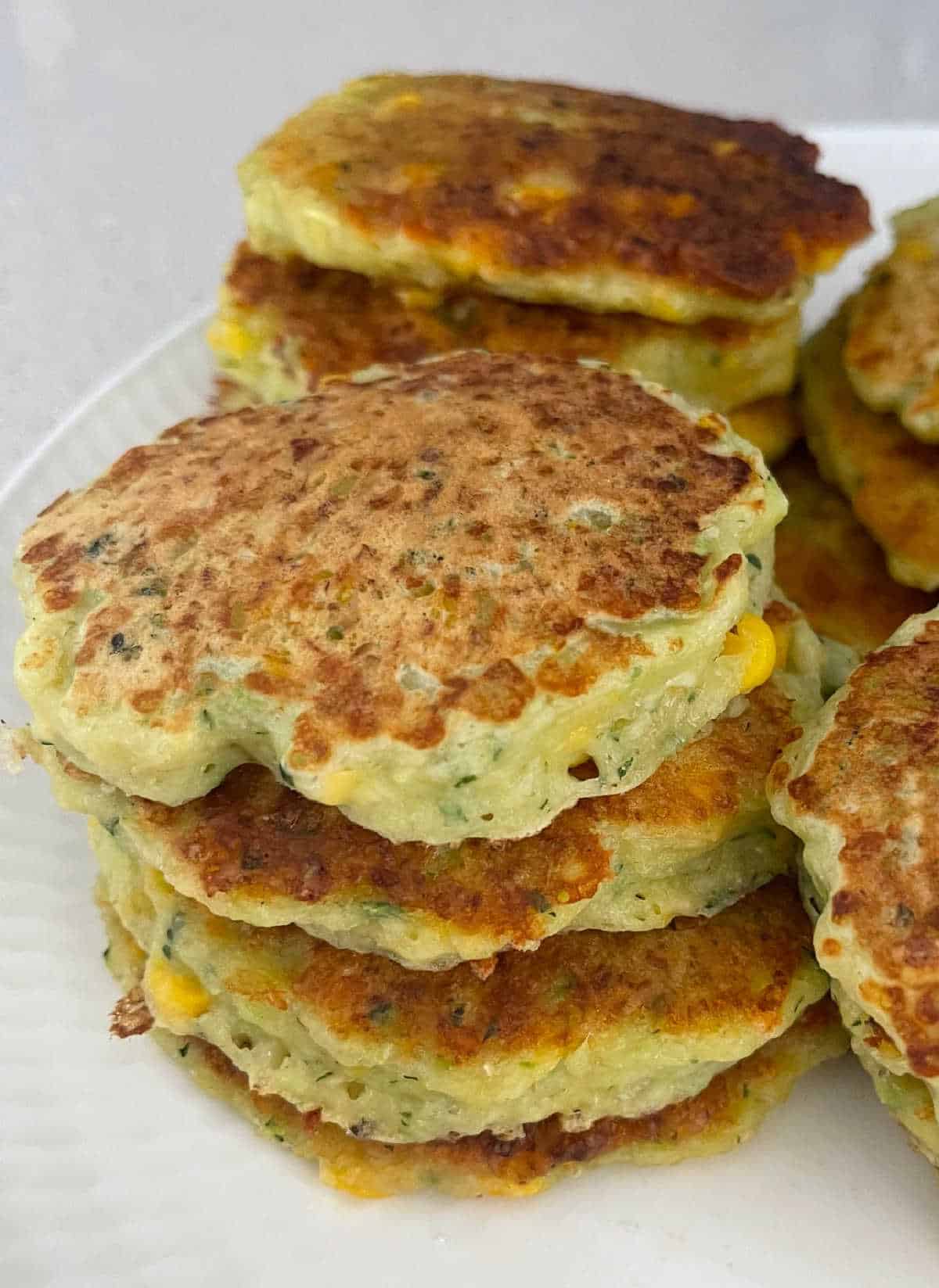 stack of corn and zucchini fritters.
