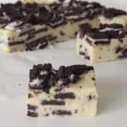 slice of White Chocolate and Oreo Fudge sitting on baking paper.
