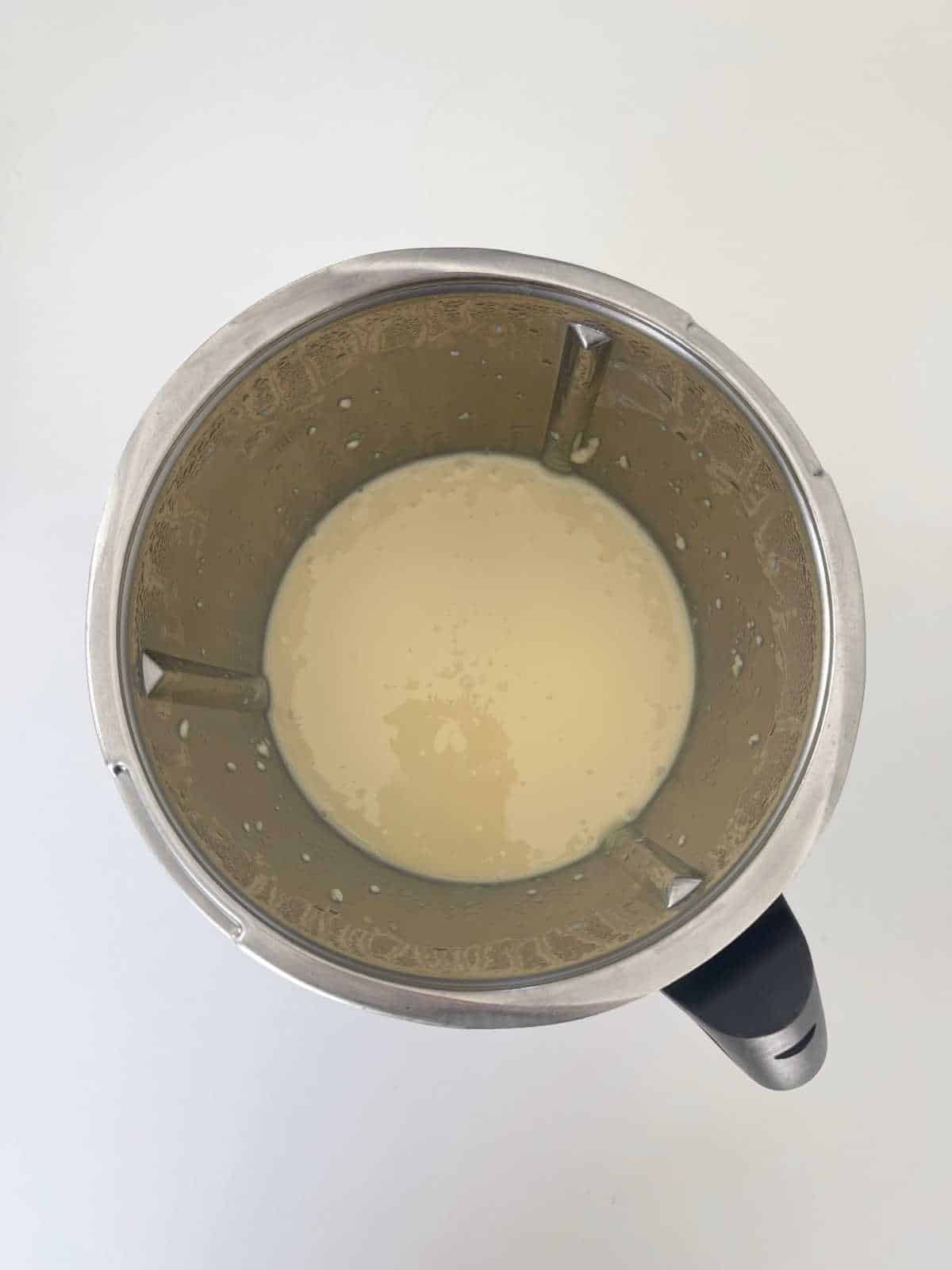 melted white chocolate and condensed milk in a Thermomix bowl.