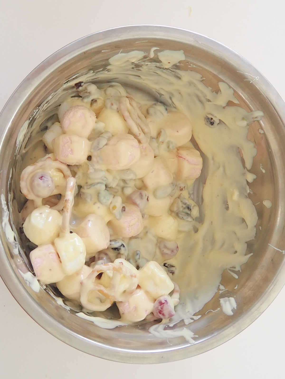 White Chocolate Rocky Road mixture in a metal bowl stirred together.