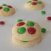 Vanilla Christmas Cookies on a white background with M&Ms scattered around.