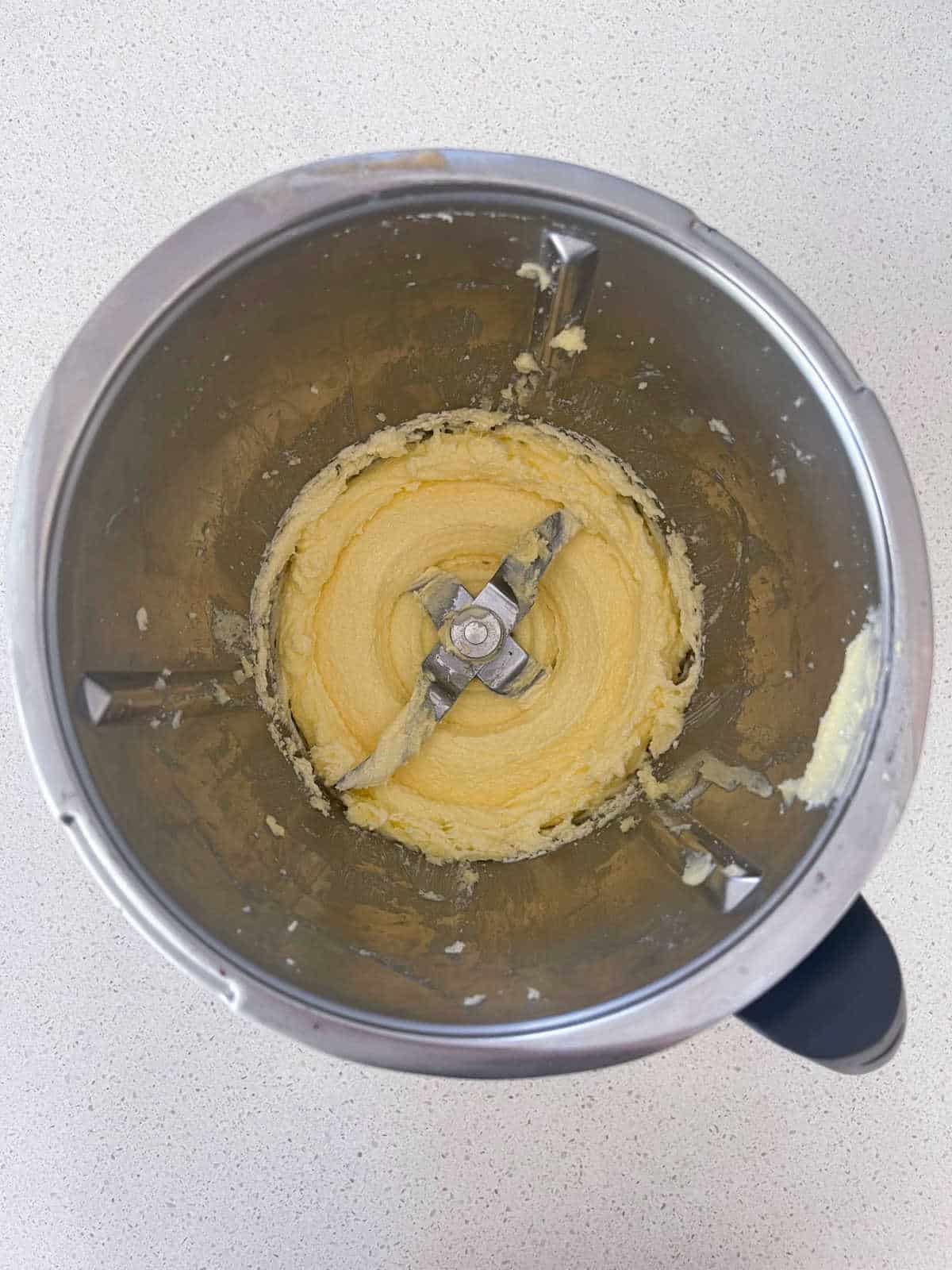 Butter and sugar combined in a Thermomix bowl.
