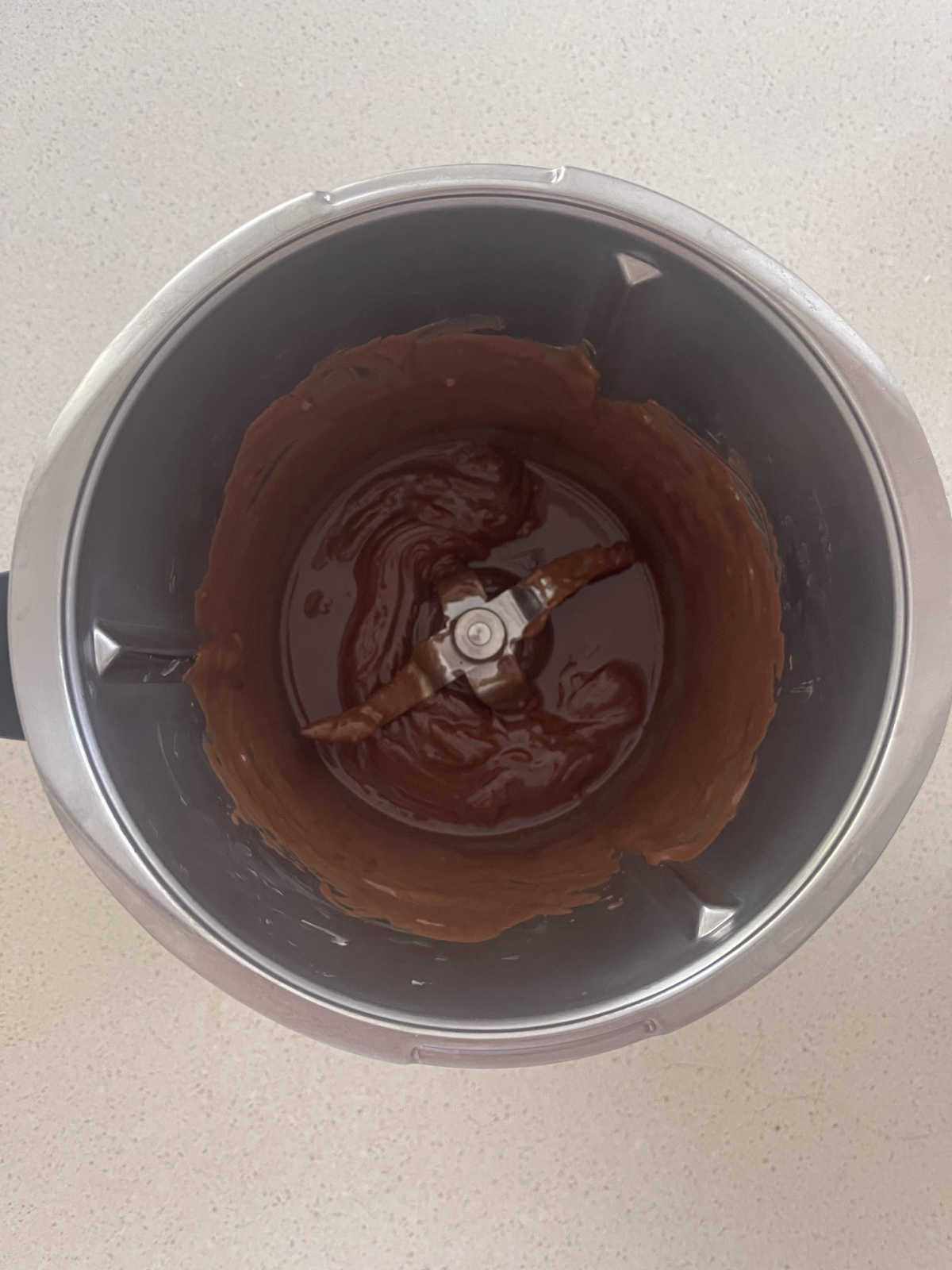 Melted chocolate and butter in a Thermomix bowl.