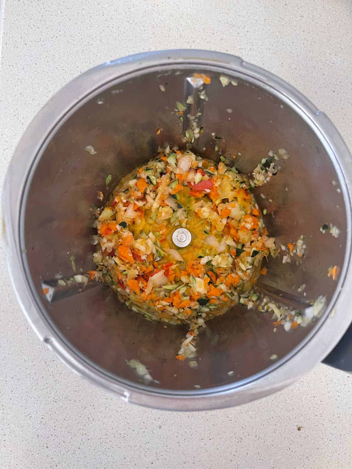 Cooked grated vegetable in a Thermomix bowl.