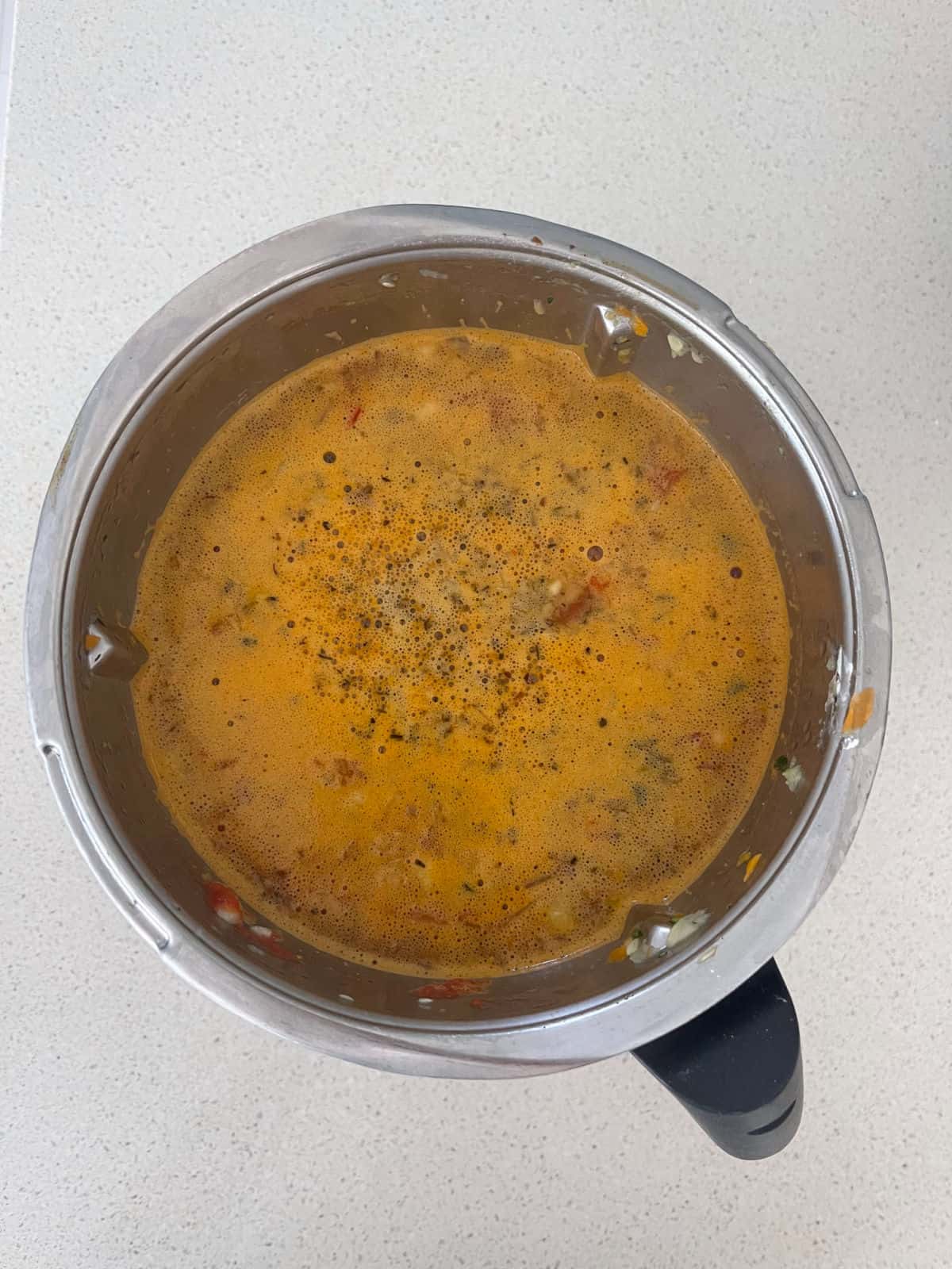 Cooked vegetable soup in a Thermomix bowl.