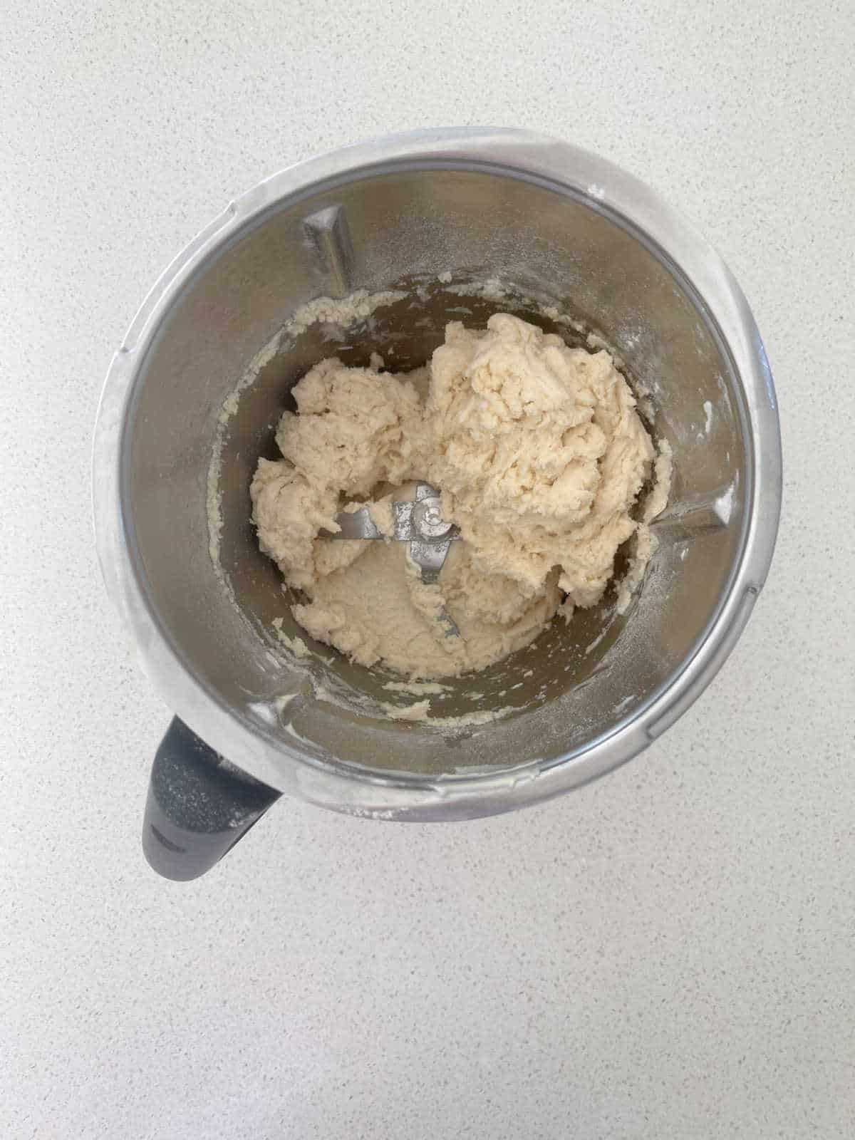 Scroll dough in a Thermomix bowl before it has been kneaded.