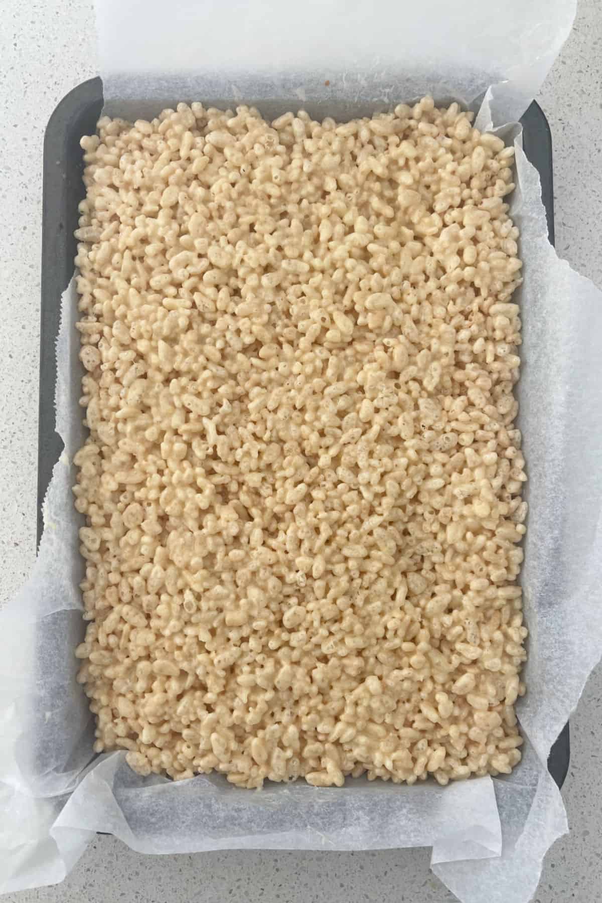 Three Ingredient Rice Bubble Slice in a baking tray.