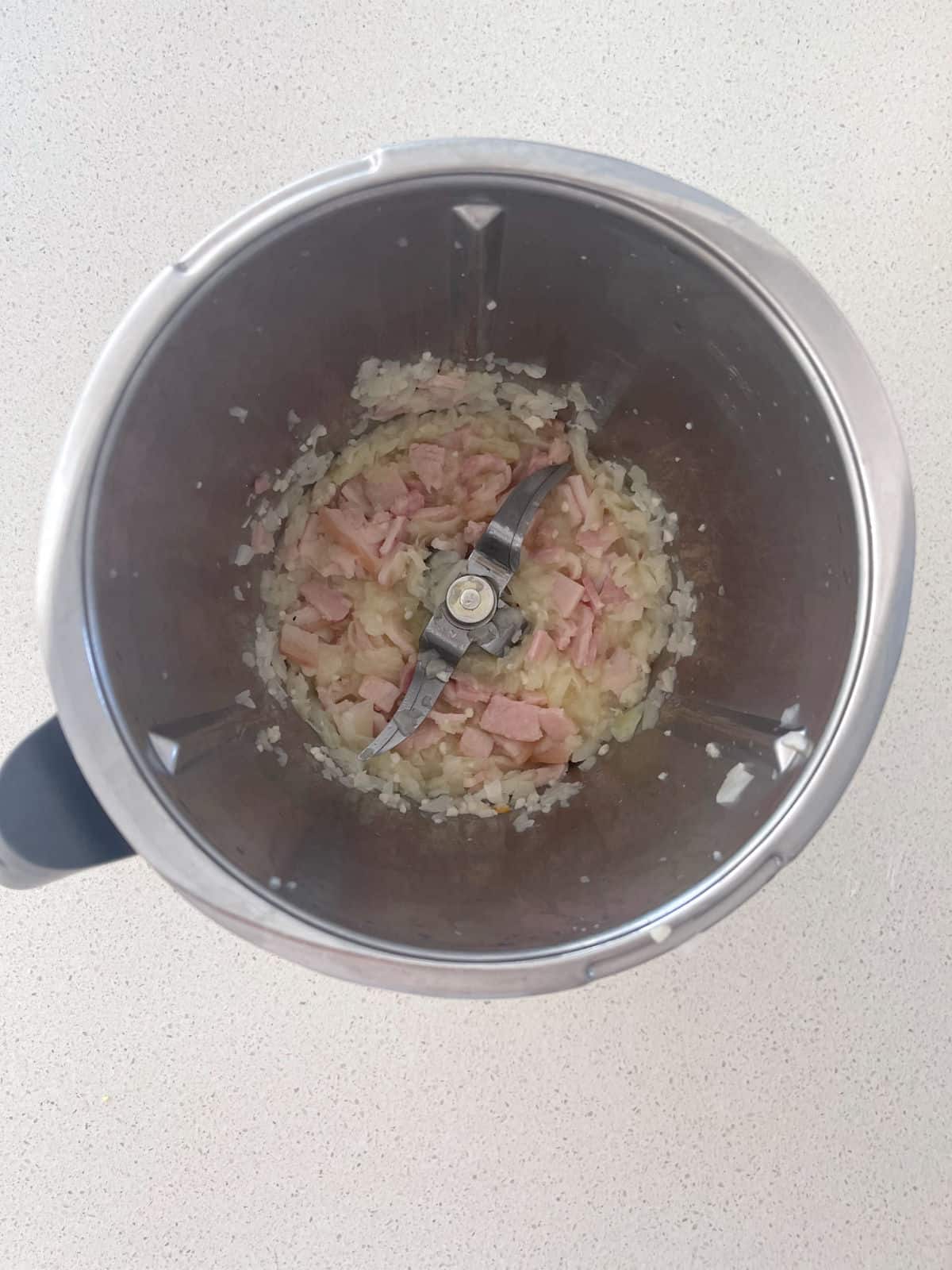Bacon and onion cooked in a thermomix bowl.