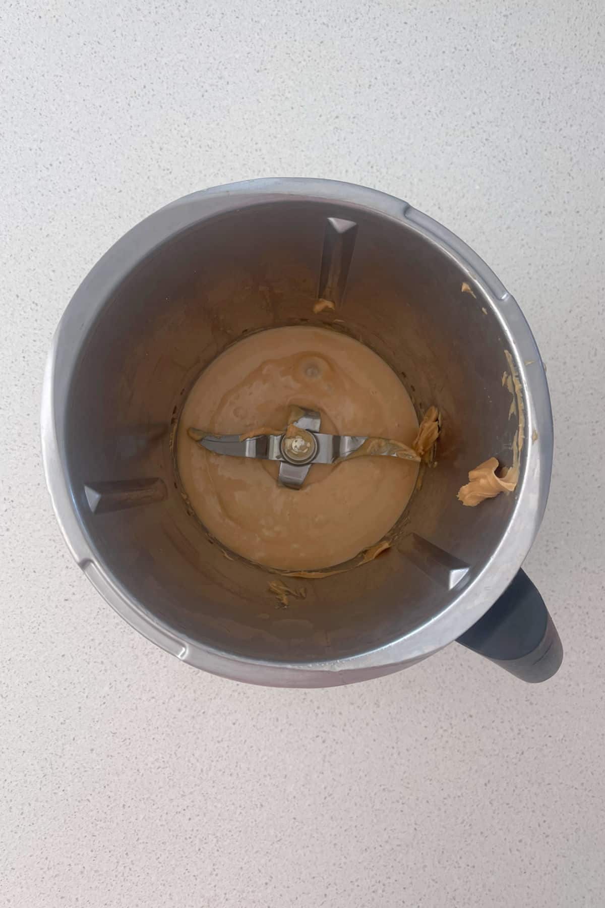 Melted peanut butter and honey in a thermomix bowl.