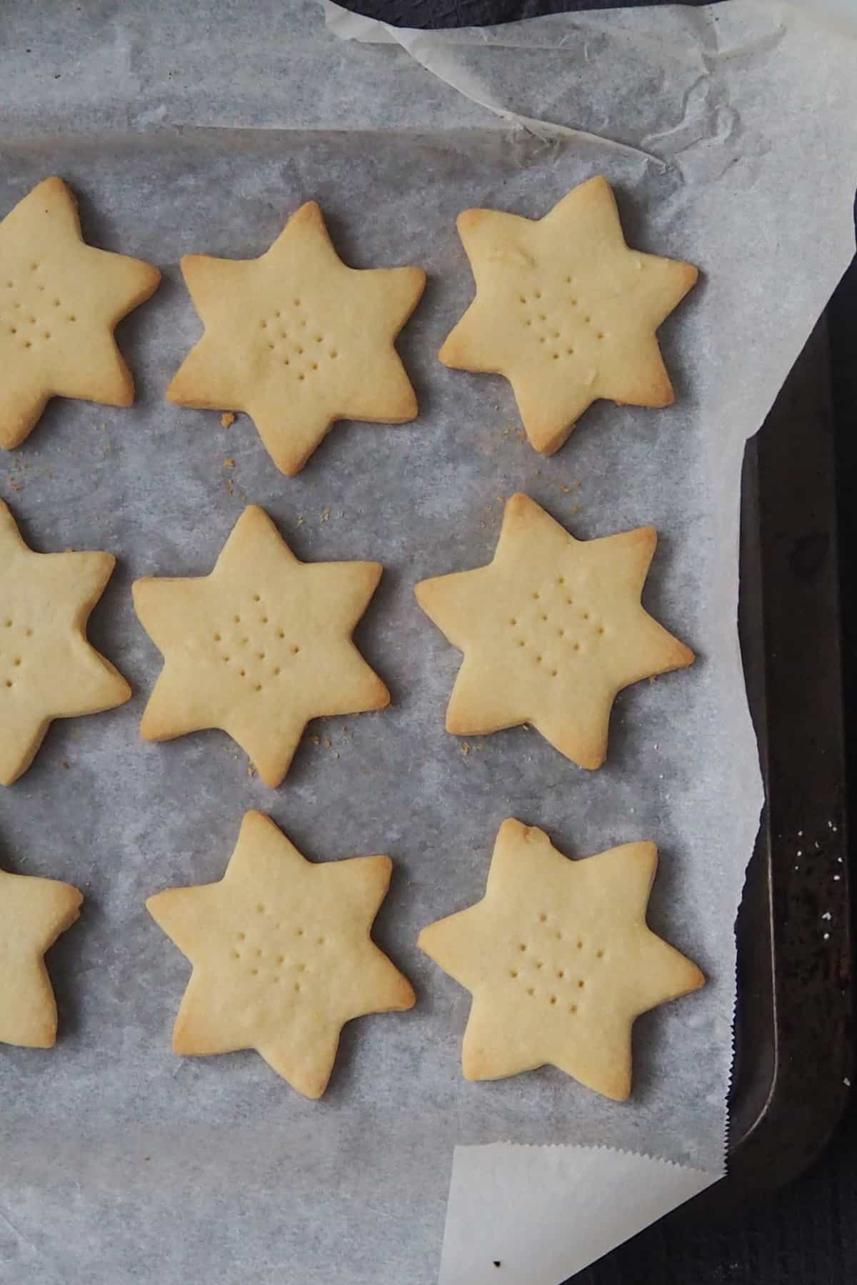 Shortbread Stars on a baking tray straight from the oven.