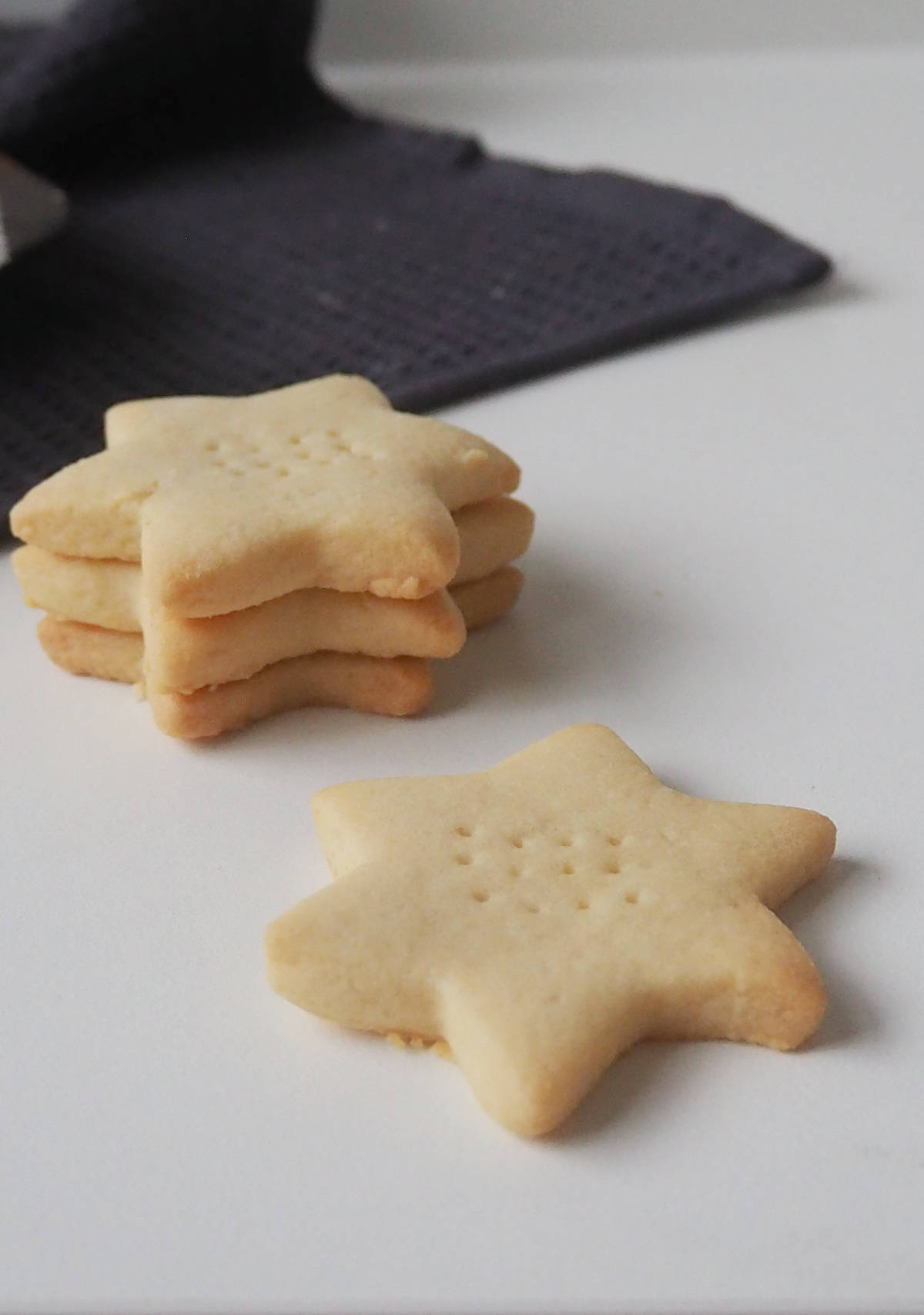 4 shortbread biscuits on a white bench.