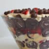 side view of a chocolate trifle in a glass bowl.