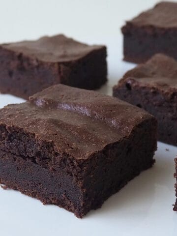 Slices of Thermomix Brownies on a white bench.