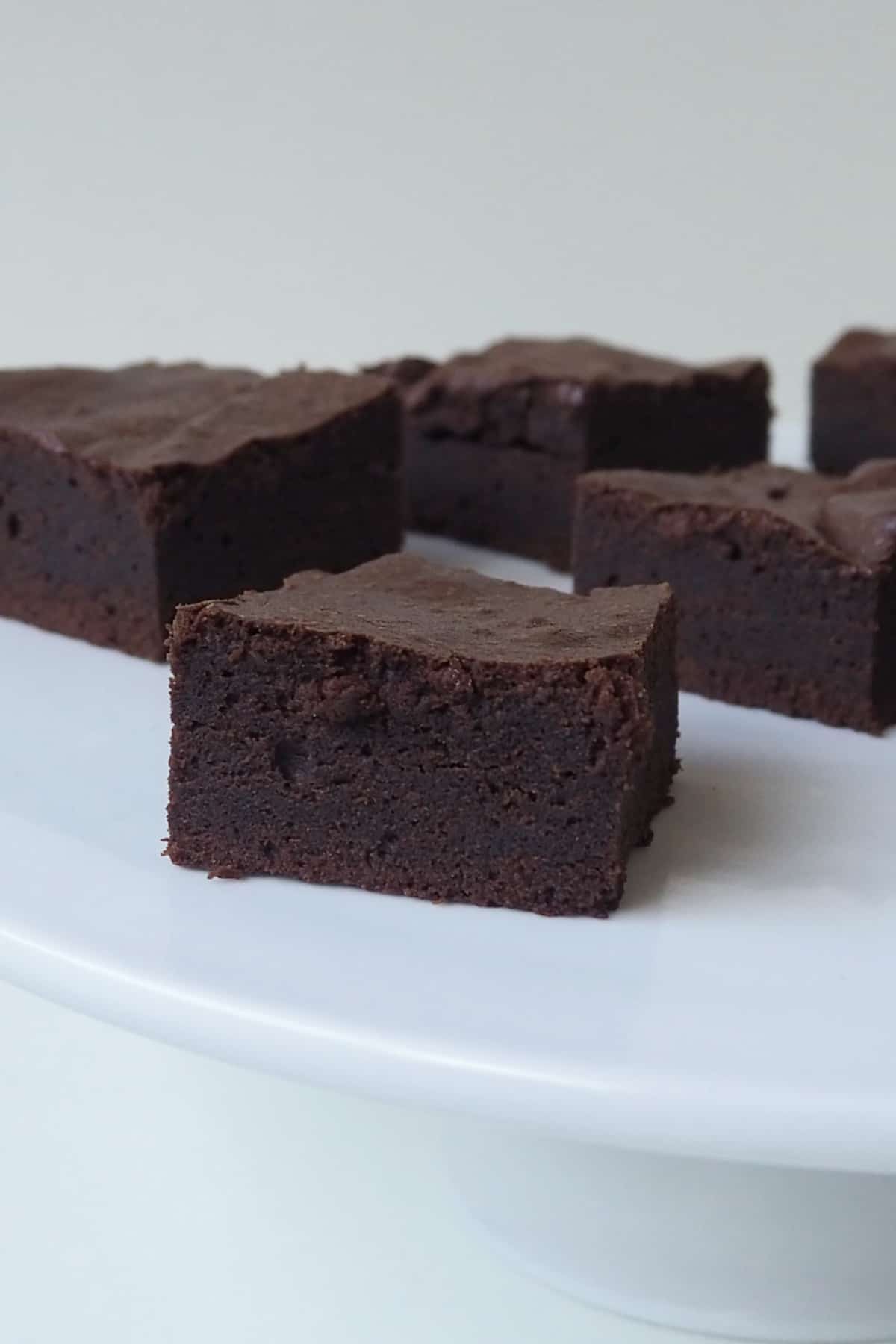 Front view of Slices of Thermomix Brownies on a white bench.