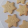Close up of shortbread stars on a white plate.