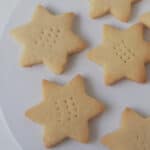 Close up of shortbread stars on a white plate.