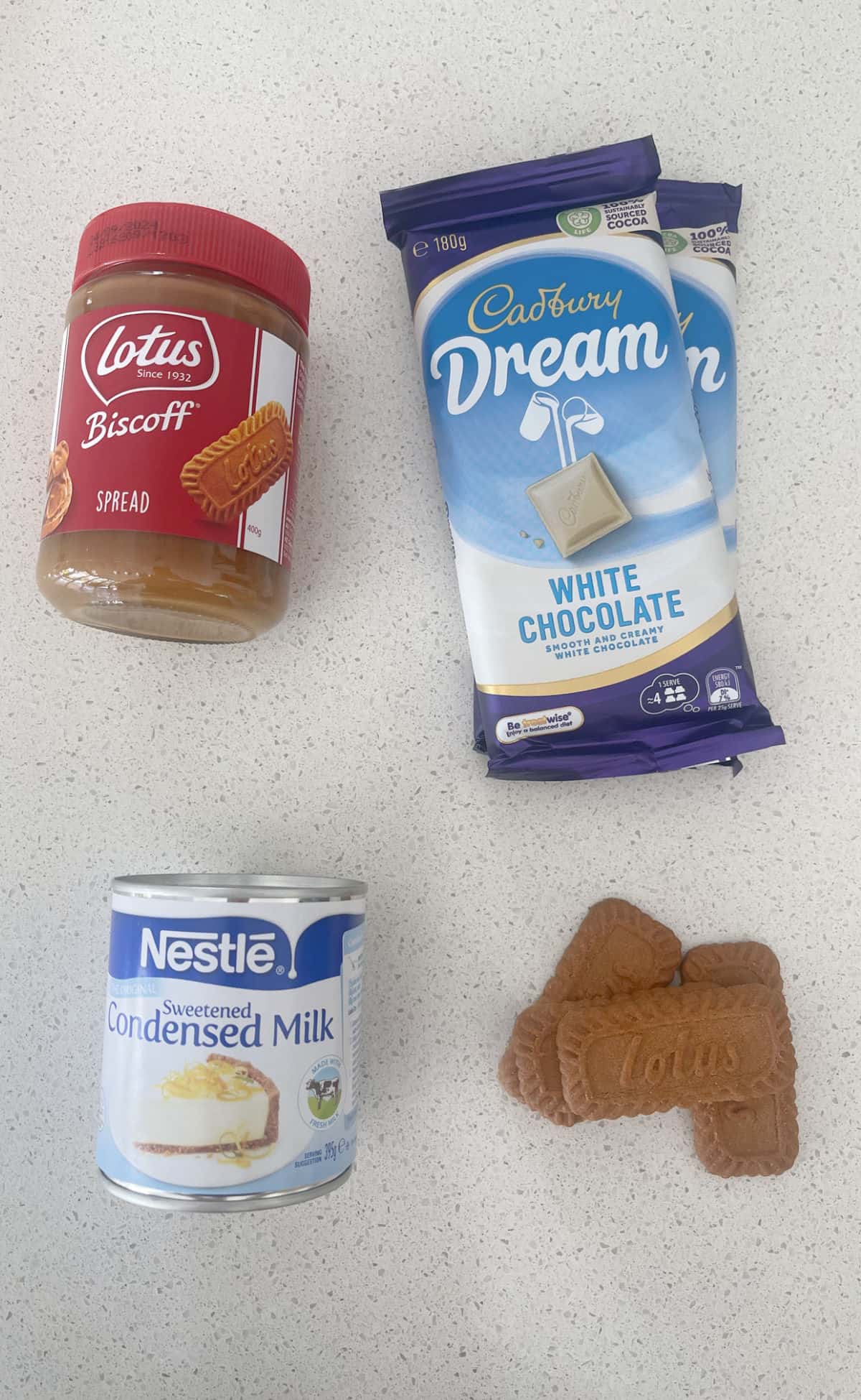 Ingredients to make Biscoff Fudge on a speckled bench top.