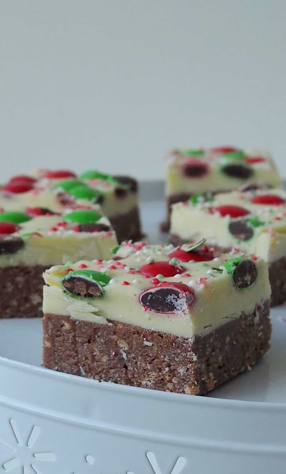 Side view of pieces of Christmas Slice on a white serving platter.